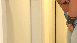 Desperately Wetting Jeans in Front of Busy Bathroom