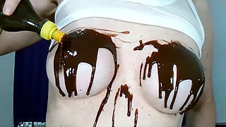 Wetting boobs, tities and nipples with chocolate