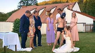 A man in a dog mask is fucking the bride while outside