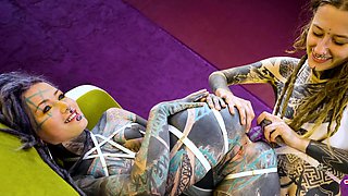 Tattooed hotties fuck each other with crazy toys