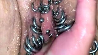 Ugly stretched cunt with pierced labia gets fisted closeup