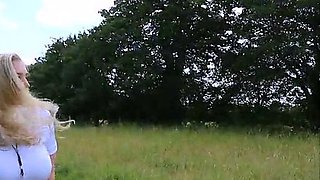 Blonde is flashing her big boobs in the outdoors