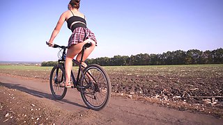 Girl Rides a Bike Under Skirt White Panties
