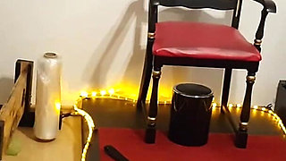 Curvy Brunette Dominatrix Commands Bound Slave in Fetish Dungeon