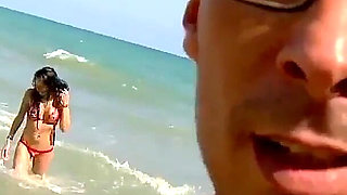 Raquel Abril a cheating whore with brown hair enjoys screaming with pleasure while fucking on a beach